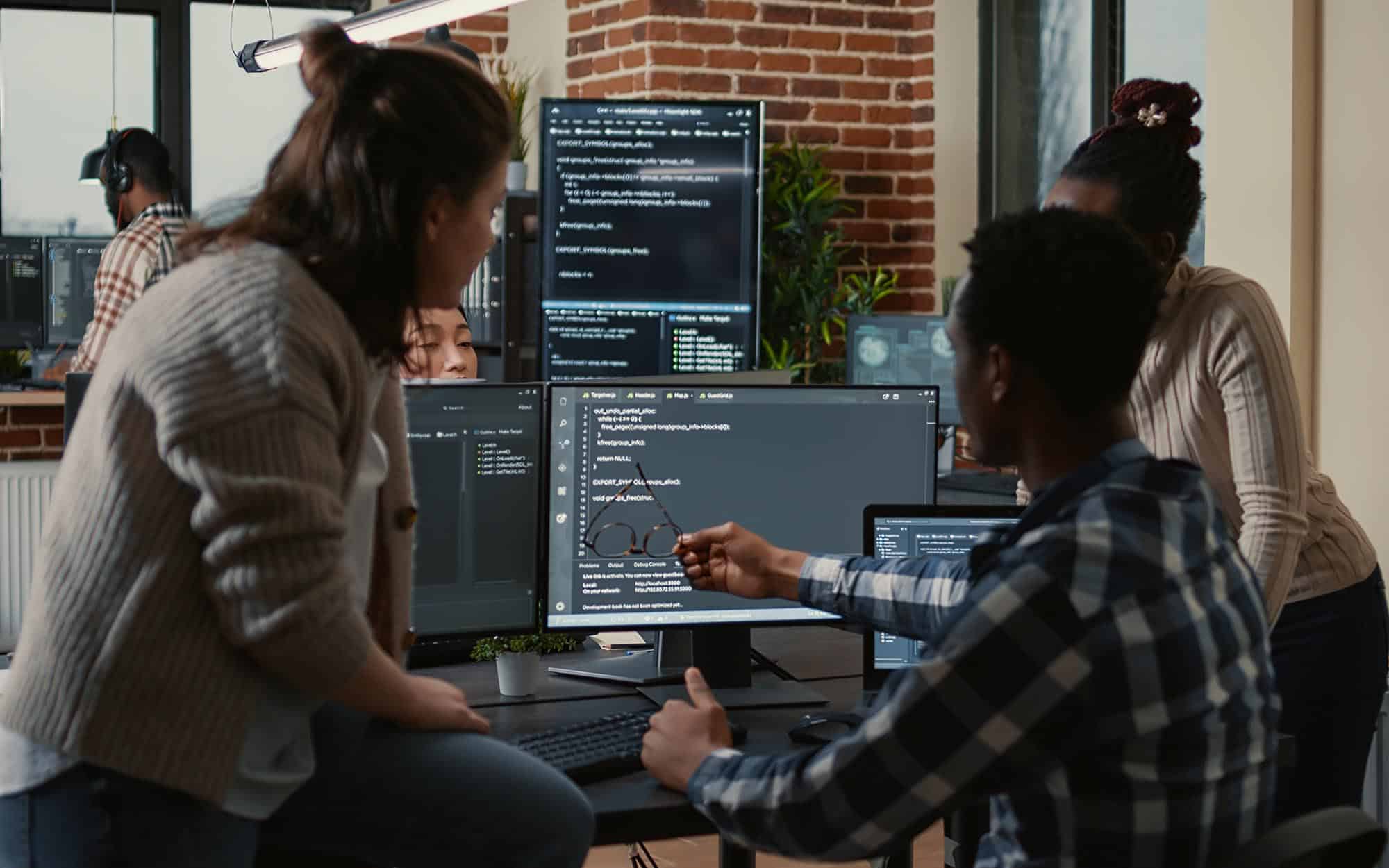 Team-of-people-reviewing-code-on-a-computer.